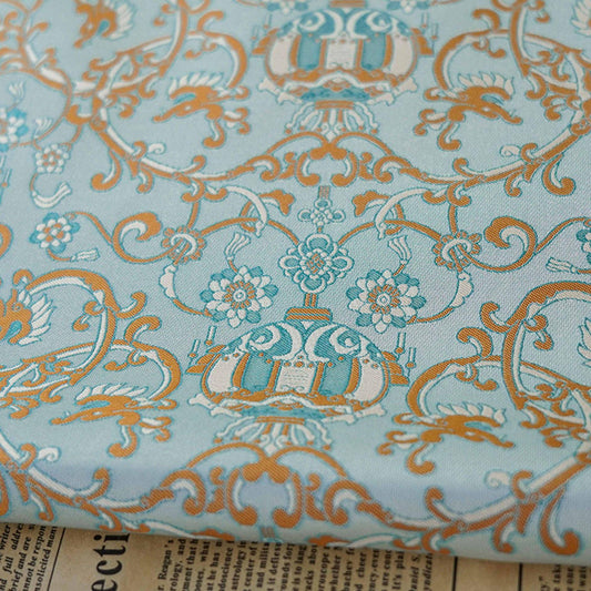Tissu brocart jacquard bleu turquoise : motif lanterne florale, 150 cm de large