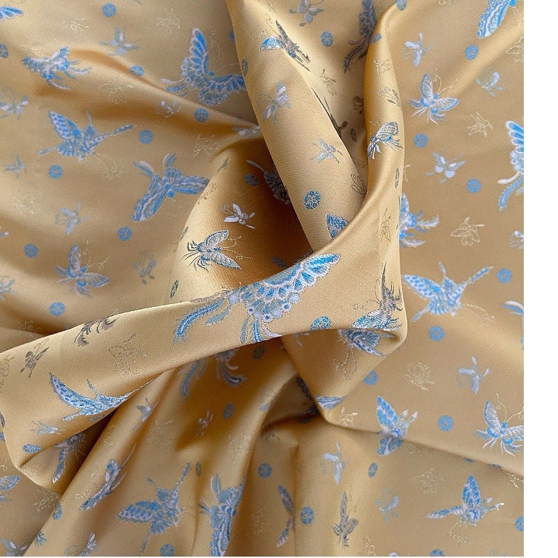Tissu brocart papillon orange : jacquard imitation soie, 150 cm de large