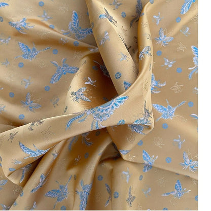 Tissu brocart papillon orange : jacquard imitation soie, 150 cm de large