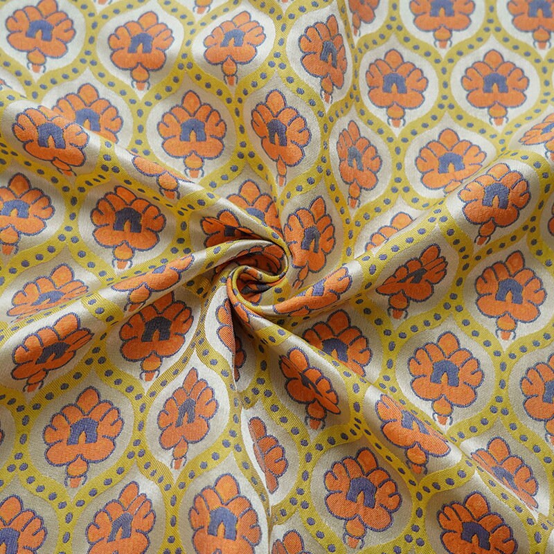 Tissu jacquard réversible : motif rétro orange en relief, 165 cm de large