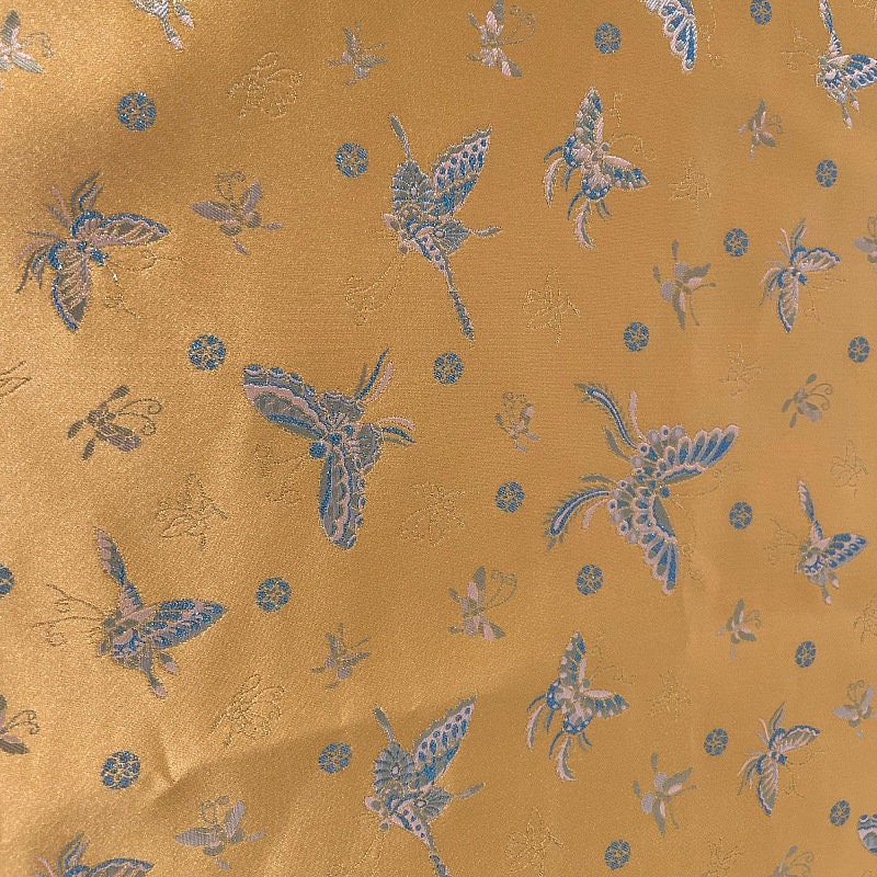 Tissu brocart papillon orange : jacquard imitation soie, 150 cm de large