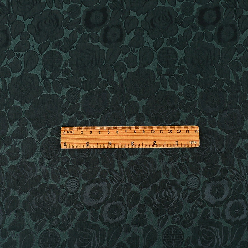 Tissu imprimé floral vert foncé : mélange bicolore de polyester et d’élasthanne, 150 cm de large