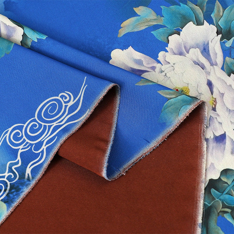 Tissu à imprimé floral papillon : Mélange de polyester et d'élasthanne bleu à motifs botaniques