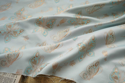 Tissu jacquard à motif papillons et feuille d'or Aqua : chenille pour ameublement, 142 cm de large