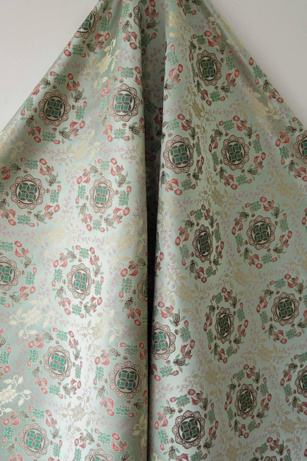Tissu jacquard réversible bleu turquoise : motif poissons en relief, 165 cm de large