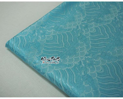 Tissu brocart à motif vagues turquoise : jacquard de soie et rayonne, 74 cm de large