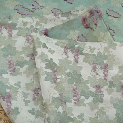 Tissu jacquard raisin : polyester gaufré doré et bronzé