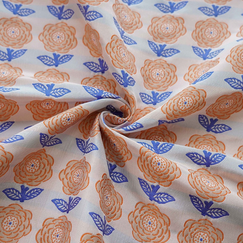 Tissu jacquard réversible : motif rétro orange en relief, 165 cm de large