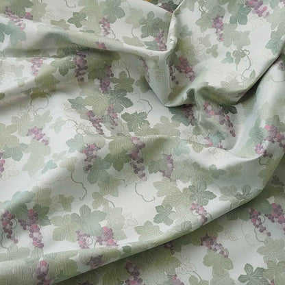 Tissu jacquard raisin : polyester gaufré doré et bronzé