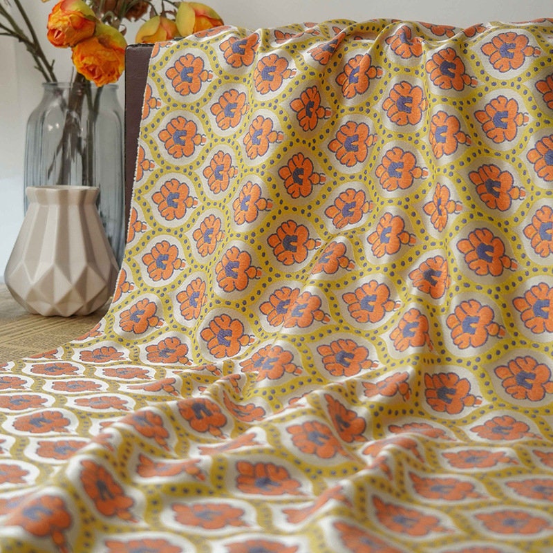Tissu jacquard réversible : motif rétro orange en relief, 165 cm de large